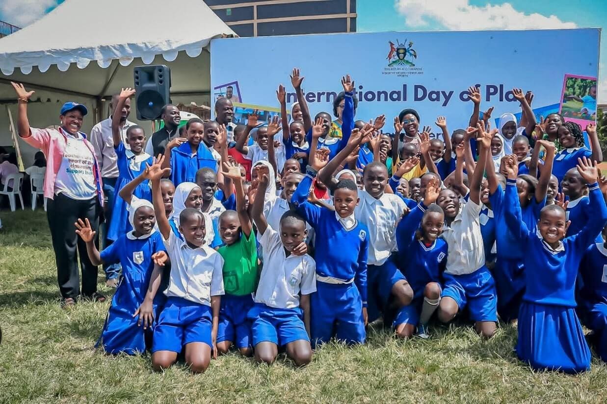 Children pose for a photo with Hon Joyce Moriku Kaducu, State Minister for Primary Education, at Nakivubo Blue Primary School - Kulea Watoto