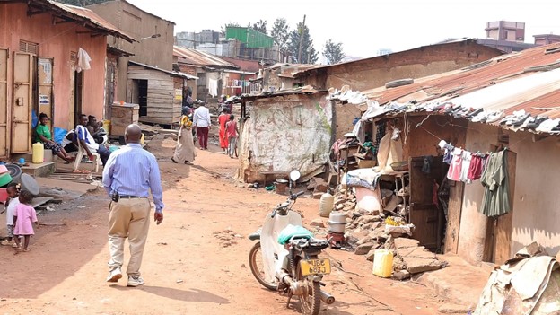 Kiberu Hassan, Chairperson of the Community Management Committee (CMC) at Kiti Nursery School, walks through the community in Katwe, Kampala Central